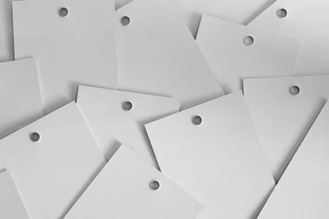 Abstract white background full of scattered one color cardboard tags for clothes Stock Photos