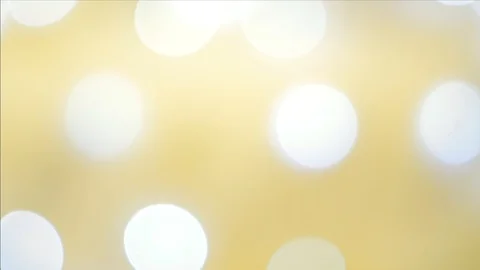 Abstract white bokeh effect on defocused bright yellow background Vídeo Stock 99917789