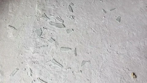 Abstract White Concrete Surface with Scattered Glass Fragments Closeup Stock Footage 336298484