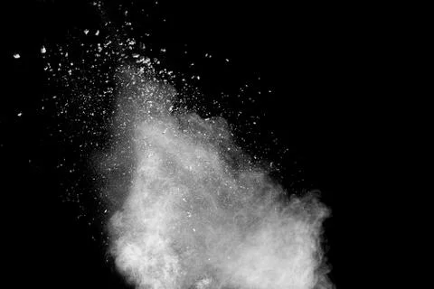 Abstract white dust explosion on  black background. Stock Photos