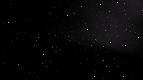 Abstract white dust particles falling on a black background creating a magi.. Vídeo Stock 335027839