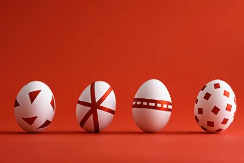 Abstract white Easter eggs with red geometric pattern on red matte background Stock Photos
