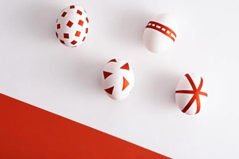 Abstract white Easter eggs with red geometric patterns on red and white backg Stock Photos