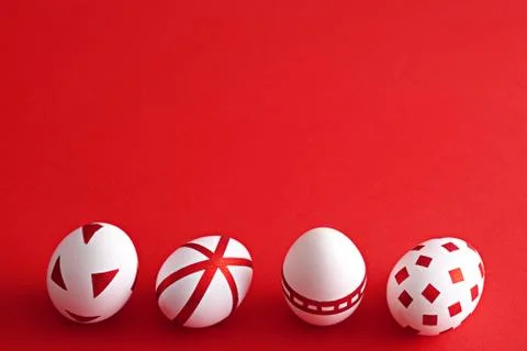 Abstract white Easter eggs with red geometric patterns on red background 库存照片