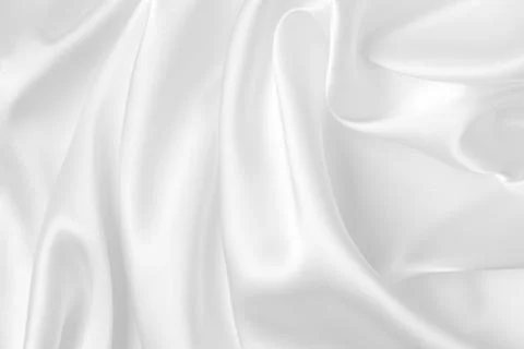 Abstract white fabric texture background. Cloth soft wave. Creases of satin.. Stock Photos