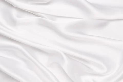 Abstract white fabric texture background. Cloth soft wave. Creases of satin.. Stock Photos