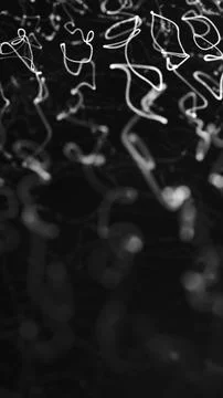Abstract white glowing scribble-like trails floating in darkness with soft .. Illustrazione stock