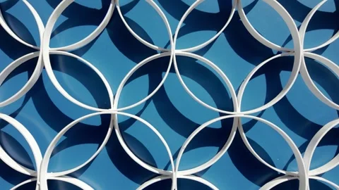 Abstract White Interlocking Circular Pattern on Blue Background Stock Footage 335161157