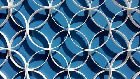 Abstract White Interlocking Circular Pattern on Blue Background Stock Photos