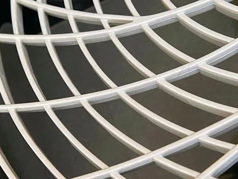 Abstract white plastic grid pattern on dark background Stock Photos