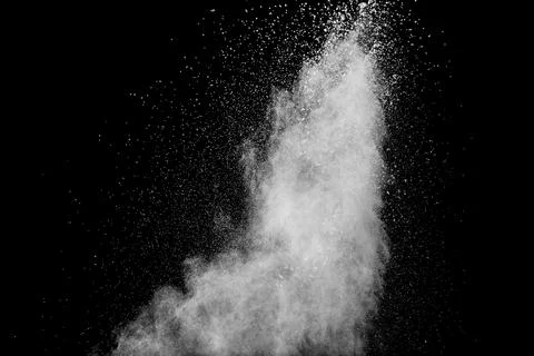 Abstract white powder splatter on black background,Freeze motion of color p.. Stock Photos