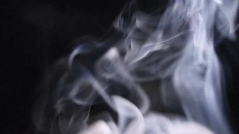 Abstract white smoke on a black background creating a graded smoke pattern Stock Footage 124430422