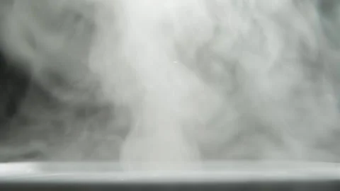 Abstract white smoke on a black background. White steam moves on a dark Video stock 154638192
