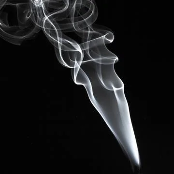 Abstract white smoke swirls pattern over the black background Stock Photos