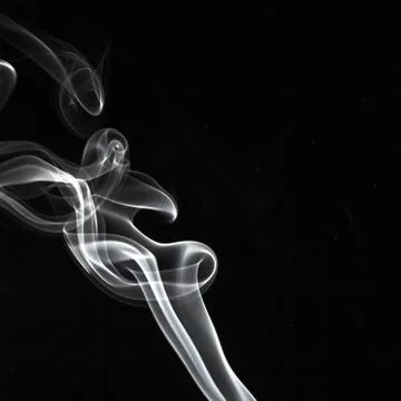 Abstract white smoke swirls pattern over the black background Stock Photos