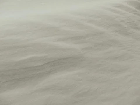 Abstract white snow texture with wind-blown ripples and soft shadows Stockfoto's