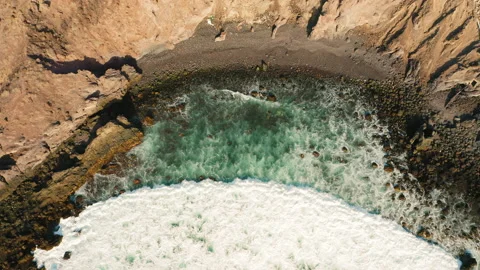 Abstract wide foamy ocean waves crashes on rocks and emerald azure water enters Stock Footage 221568533