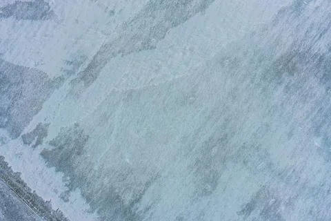 Abstract Winter Landscape Surface with Soft Snow Drifts and Blue Ice Patches Stock Photos