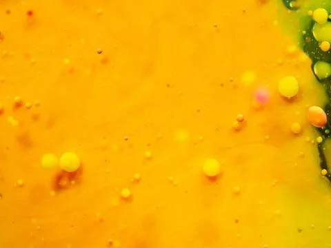 Abstract yellow background. Close up macro shot of bubbles and paint drops Stock Photos
