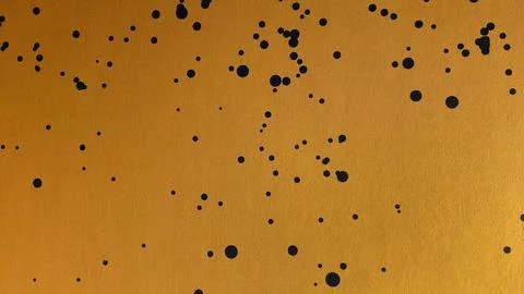 Abstract yellow with black dot painted wall background or art wallpaper. Stock Photos