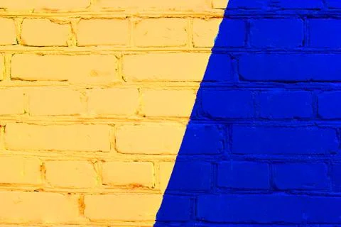 Abstract yellow brick wall texture depicting in paint colors on an old brick Stock Photos