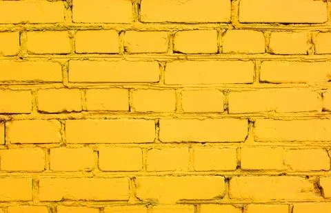 Abstract yellow brick wall texture depicting in paint colors on an old brick Stock Photos
