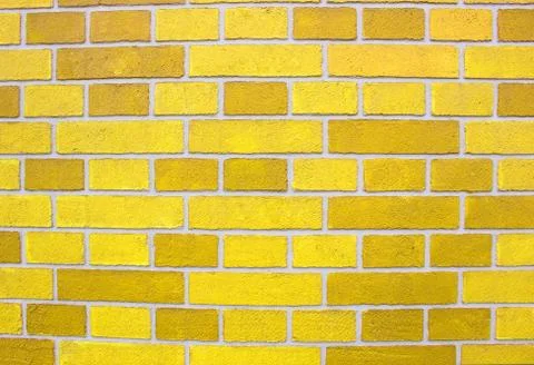 Abstract yellow brick wall texture depicting in paint colors on an old brick Stock Photos