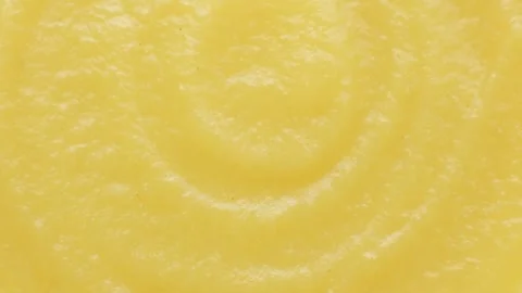 Abstract yellow fruit sauce background with swirl pattern. Stock Footage 332795186