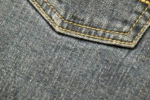 Abstraction blurred image of close up texture of back pocket blue denim jeans Stock Photos