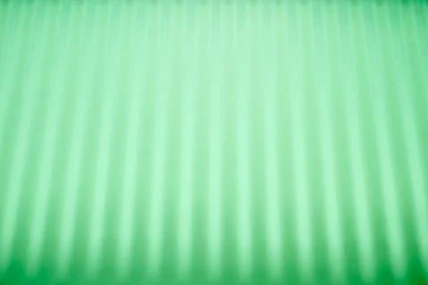 Abstraction created by the straight shadows of a grid on a green surface. 스톡 사진