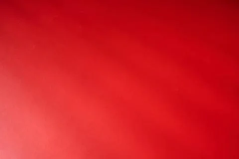 Abstraction created by the straight shadows of a grid on a red surface. 스톡 사진