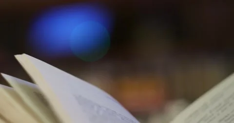 Abstraction. The man was holding an open book on a colored background. Stock-Footage 167580412