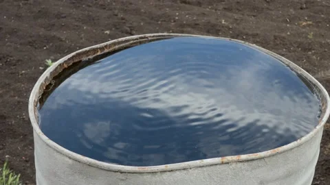 Abstraction. The sky and clouds are reflected in a water-filled barrel. 스톡 동영상 154496050
