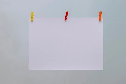 Abstraction. White sheet and colored clothespins. Stock Photos