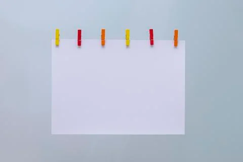 Abstraction. White sheet and colored clothespins. Stock Photos