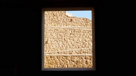 Abstraction. a window in the black wall, through which the stairs and climbs in Stock Footage 136838799