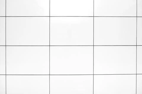 An abstrakt background of white ceramic tile on a bathroom wall or floor Stock Photos