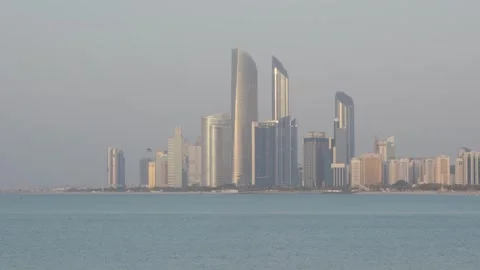 Abu Dhabi skyline with ADNOC Headquarters and Etihad Towers reflecting sunset Stock Footage 331343528