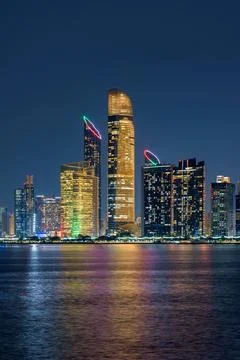 Abu Dhabi Skyline Night Reflection with Illuminated Skyscrapers and Waterfron Stock Photos