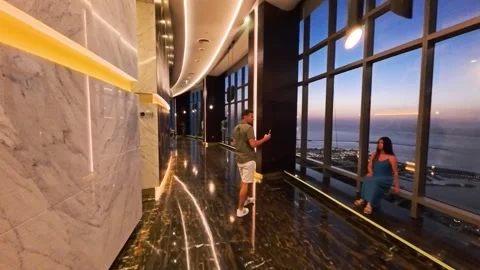 Abu Dhabi, UAE - 04.29.2025, POV walk along interior cafe of Observation Deck at Stock Footage 346759101