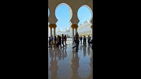 Abu Dhabi, UAE - January 23, 2026: Visitors in the famous White Mosque Stock Footage 343945337