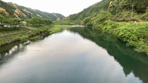 Abu river with spring mountain wide angle shot in Japanese rural area Stock Footage 107814871