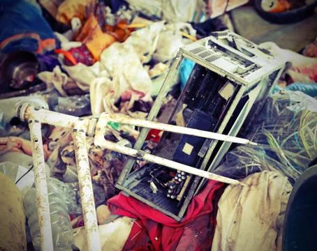 Abusive dump with a broken bicycle a piece of computer and many rags with ant Foto stock