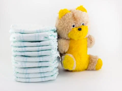 Aby diapers and soft toy on a white background Photos