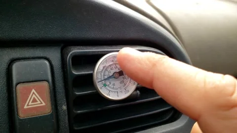 AC mechanic checking temperature of car vent Stock Footage 202612315