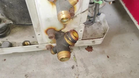 AC Outdoor Unit Service Valve with Oil Leak and Rust Air Conditioner Maintenance Stock Footage 334657091