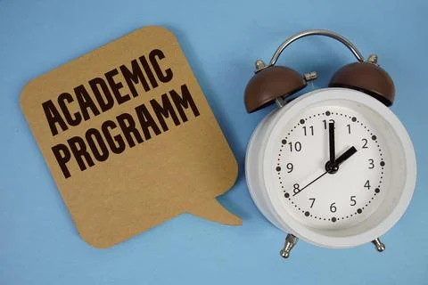 Academic Programm text with alarm clock on blue background Stock-Fotos