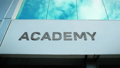 Academy Sign on Modern Building with Cloud Reflection on Windows Glass Stock Footage 303549636