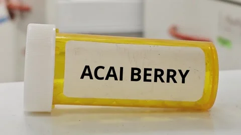 ACAI BERRY tablets used as antioxidant supplement to support overall health Stock Footage 334929328