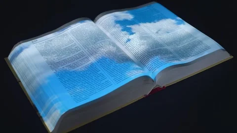Accelerated clouds filmed in time lapse are projected onto the pages of the book Stock Footage 313176066